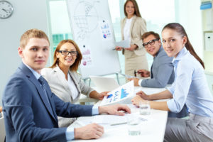Image of confident partners looking at camera during presentation